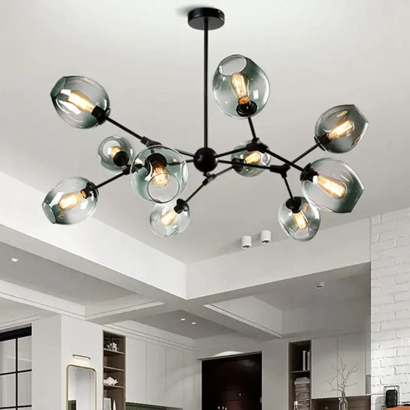 Modern black metal decorbites glass chandelier with frosted globe shades and exposed filament bulbs for dining room