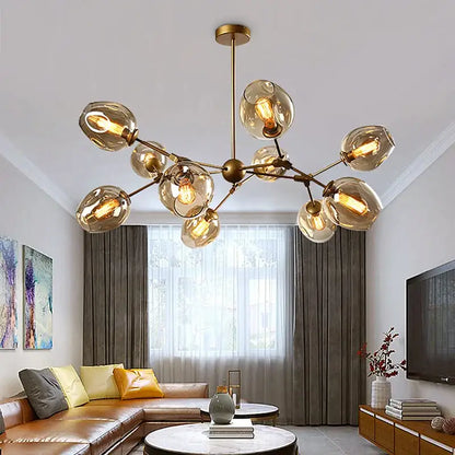 Modern black metal decorbites glass chandelier with gold-toned frame and amber globe shades for dining room lighting