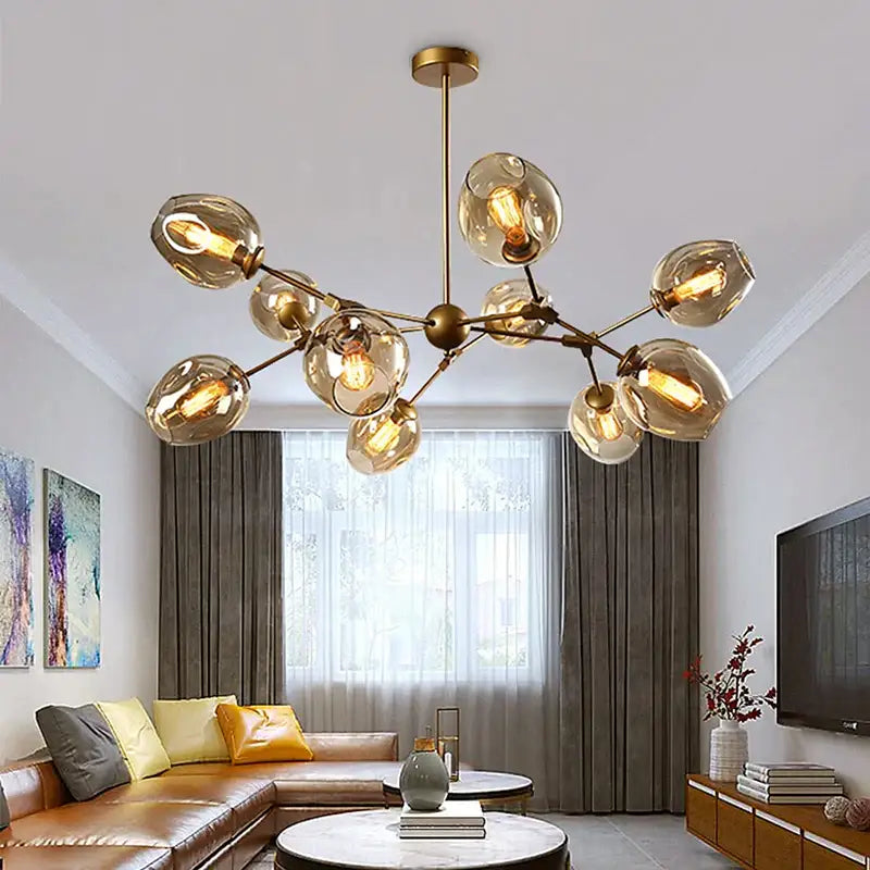 Modern black metal decorbites glass chandelier with gold-toned frame and amber globe shades for dining room lighting