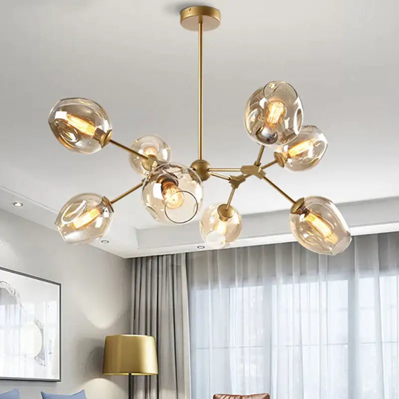 Modern black metal decorbites glass chandelier featuring gold-toned frame with frosted globes for dining room lighting