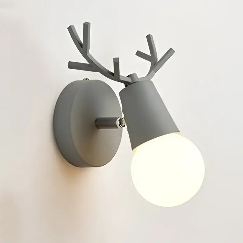 Modern black metal deer head led wall lamp with gray antler-themed sconce and exposed bulb for bedroom use