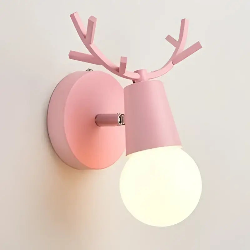 Modern black metal deer head led wall lamp in pink with antlers and frosted bulb for stylish bedroom lighting