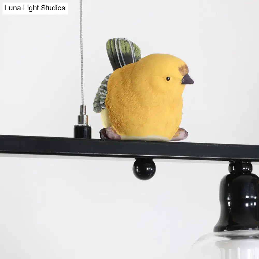 A yellow bird figurine with green and gray striped wings on a modern black metal island pendant 110v-120v light
