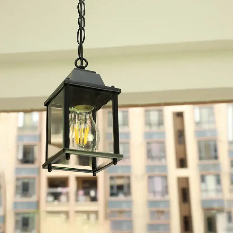 Modern black metal lantern pendant light with clear glass panels and filament bulb for decorbites garden pendant use