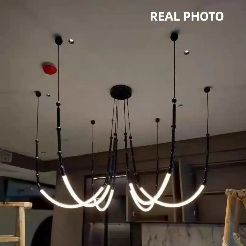 Modern black metal pendant lights with curved glowing white led strips for living room decorbites bamboo pendant style