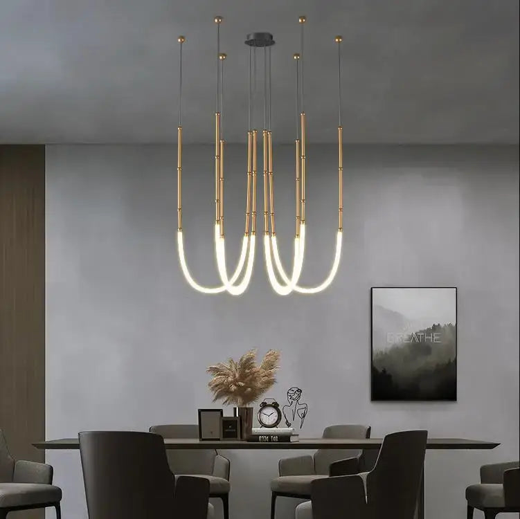 Modern black metal pendant lights with gold-toned bamboo-inspired rods and integrated LED lighting for living room decorbites bamboo pendant lights