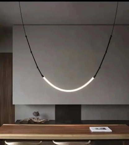A sleek black metal led pendant light with curved minimalist design hangs on black cords for living room decorbites bamboo pendant