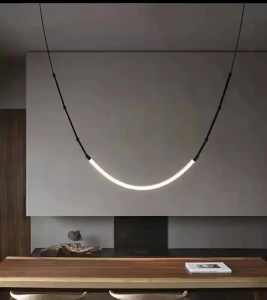 A sleek black metal led pendant light with curved minimalist design hangs on black cords for living room decorbites bamboo pendant