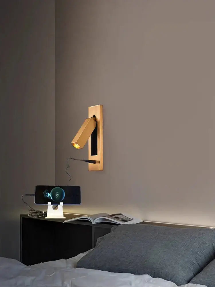 Gold-toned wall lamp with sleek modern design and adjustable head for reading featuring led technology and usb port