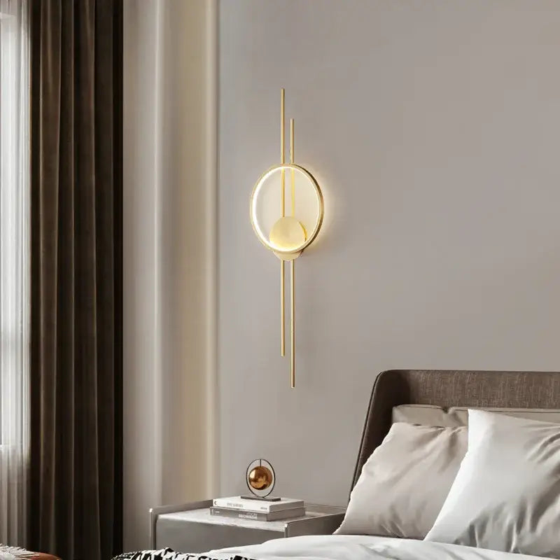 Modern black metal led wall light with gold-toned circular illuminated face and slender rods for bedroom decorbites led wall use