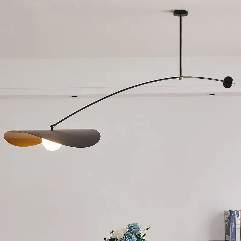 Modern black metal floor lamp with long arm and two-toned leaf shade featuring matte gray and warm amber decorbites adjustable long