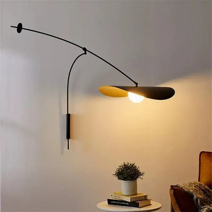 Modern black metal long arm floor lamp with curved arm and warm yellow disc shade by decorbites adjustable long