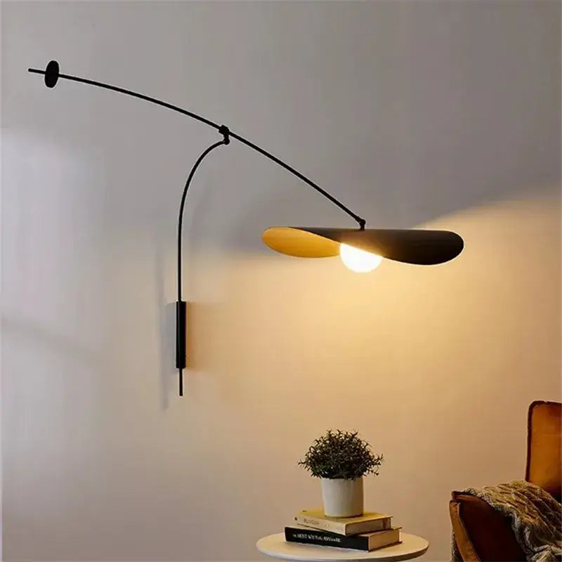 Modern black metal long arm floor lamp with curved arm and warm yellow disc shade by decorbites adjustable long