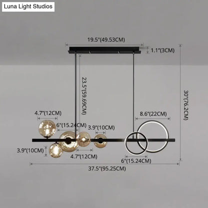 Modern black metal pendant light fixture with spherical glass globes and circular rings for dining room ceiling light