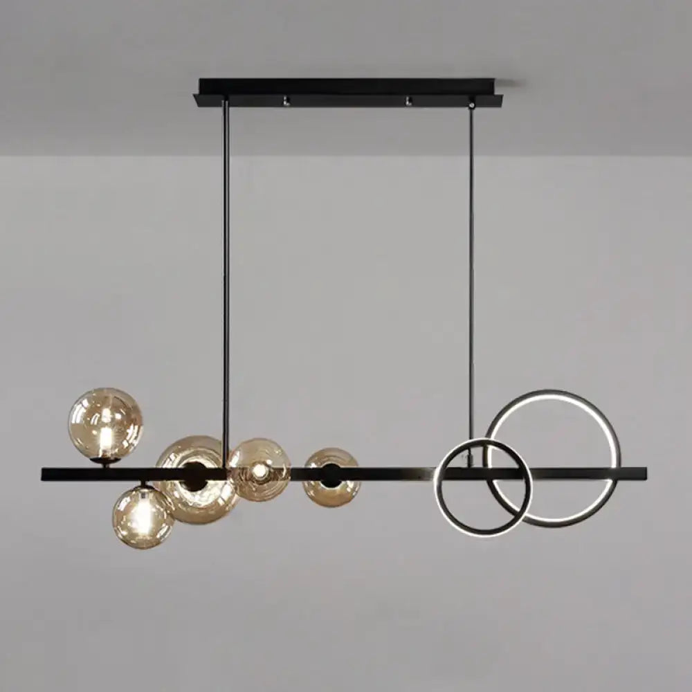Modern black metal pendant light fixture with amber glass spheres and glowing rings for dining room ceiling light