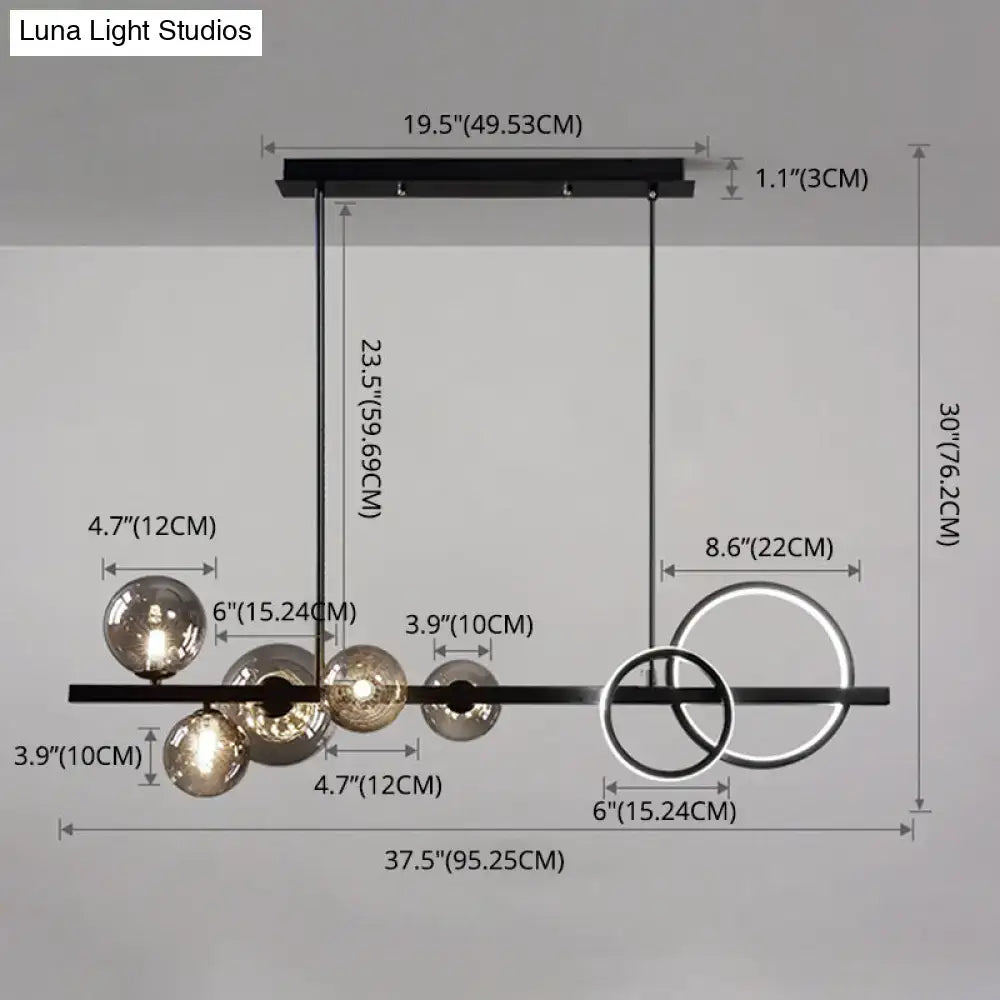 Modern black metal pendant light fixture with spherical glass globes and circular ring accents for dining room ceiling light