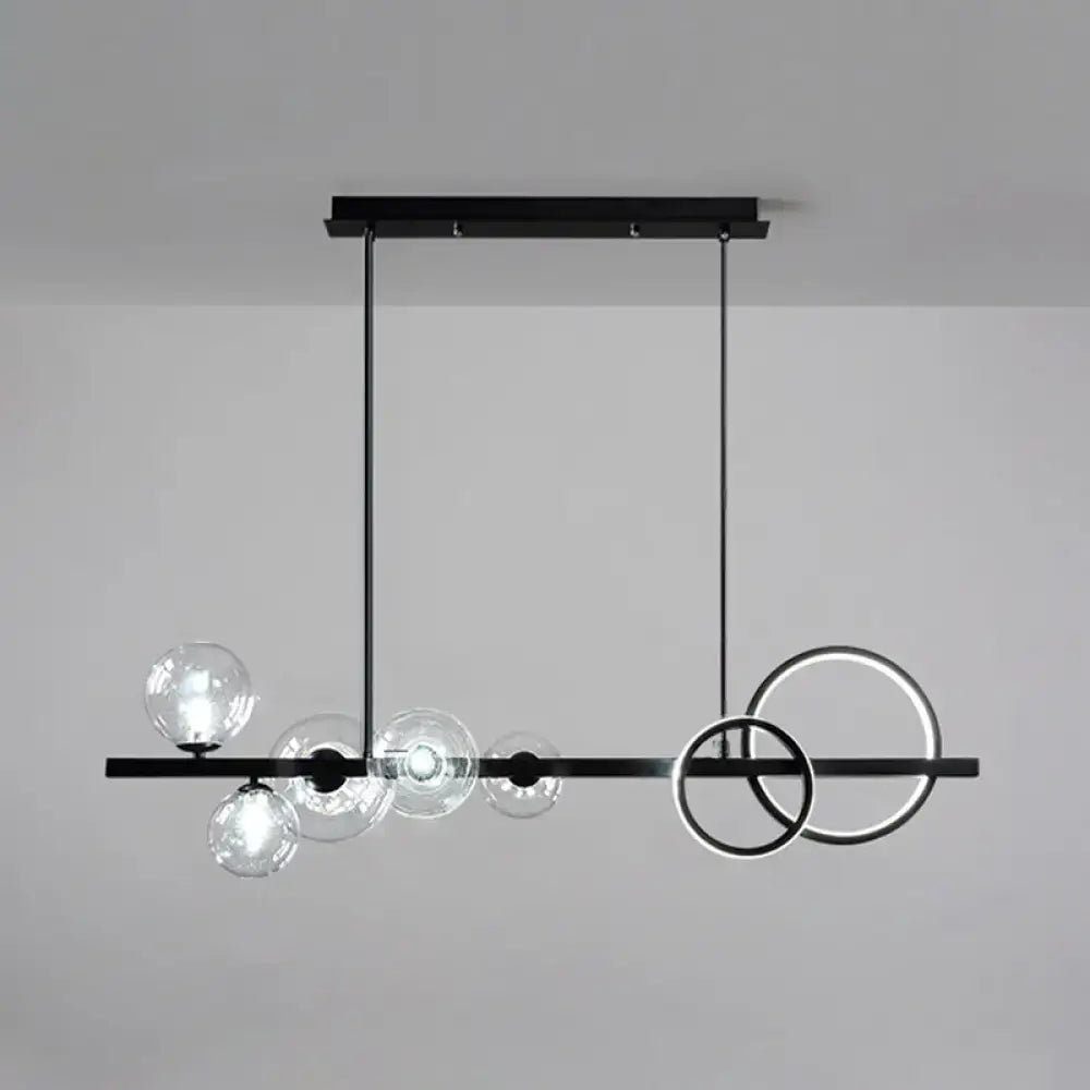 Modern black metal pendant light fixture with clear glass spheres and glowing rings for dining room ceiling light