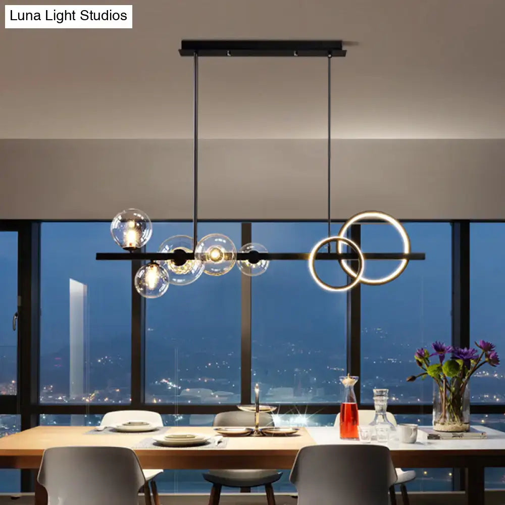Modern black metal pendant light fixture with clear glass spheres and circular rings for dining room ceiling light