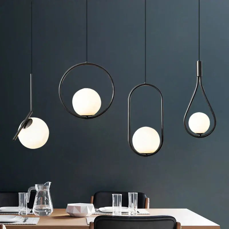 Modern black metal pendant light dining room fixture with frosted glass globe shades and geometric black metal ring design