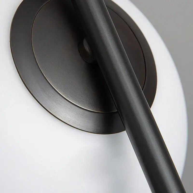 Modern black metal ring pendant light with black matte-finished cylindrical arm and circular base for dining room
