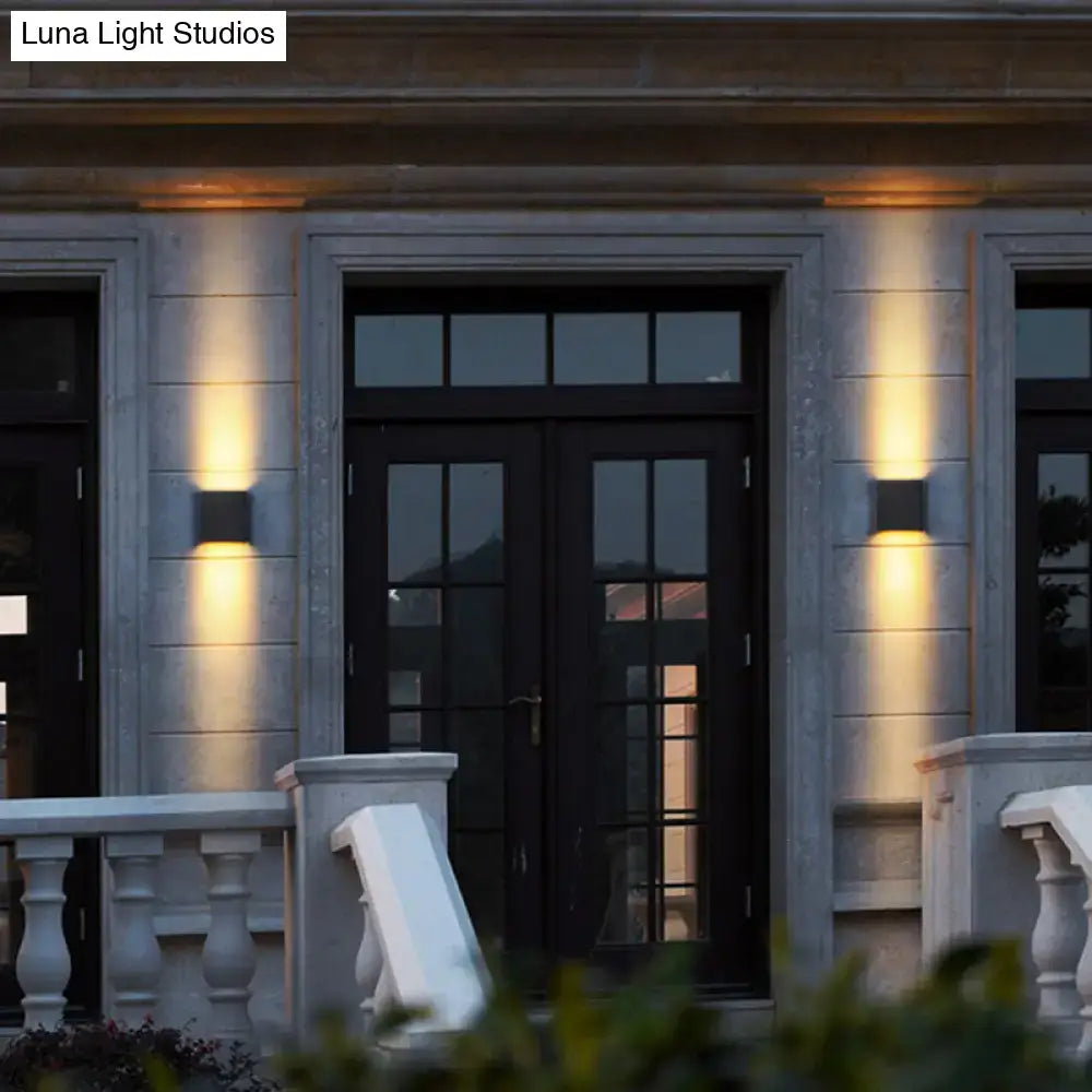 Modern black metal shade wall light with warm tones mounted on stone facade beside double doors for outdoor use 220v-240v 110v-120v