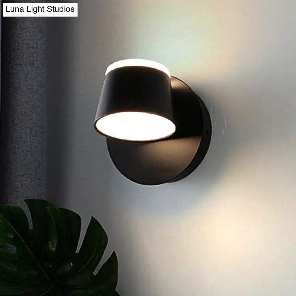 Modern black metal shade wall sconce with sleek cylindrical design and warm white LED lighting for bedroom vanity fixture