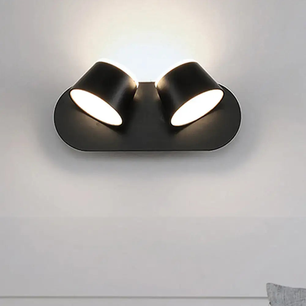 Modern black metal shade wall sconce with dual-head spotlight featuring sleek design and compact fixture width and shade height