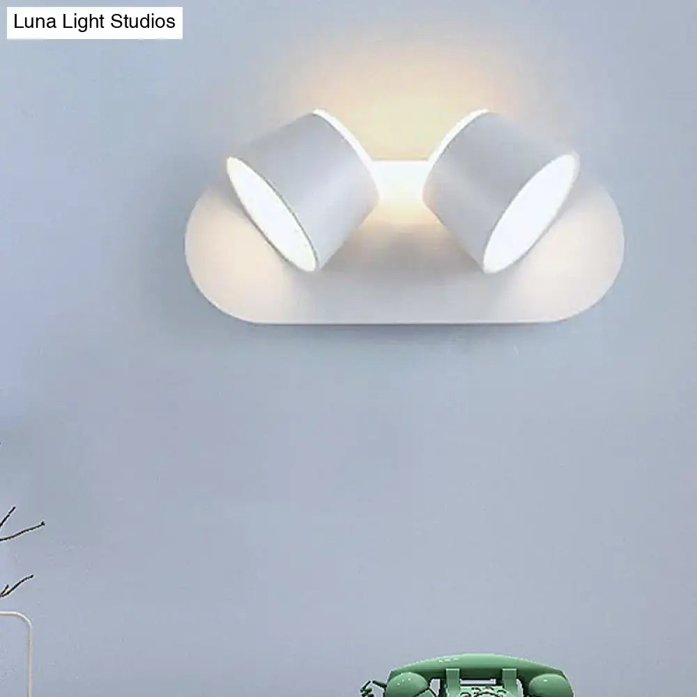 Modern white wall-mounted fixture with two cylindrical metal shade lamps for bedroom vanity with adjustable shade height