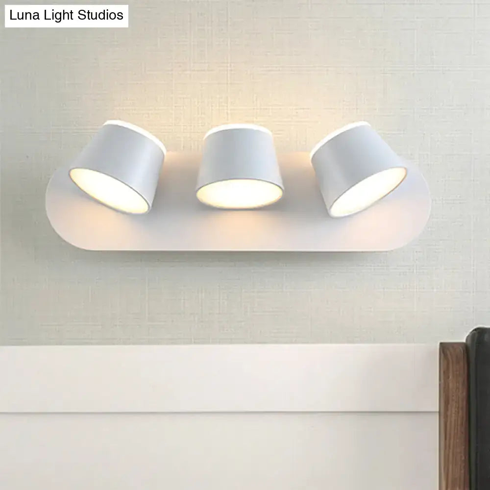 Modern black metal shade wall sconce with three adjustable white cylindrical lamp heads and fixture width and shade height details