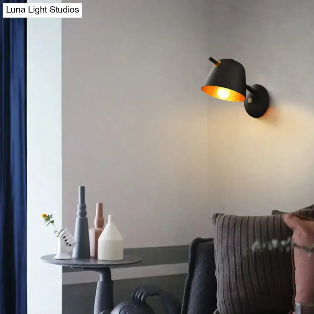 Modern black industrial-style metal shade wall sconce with adjustable arm and warm white blue bedroom light