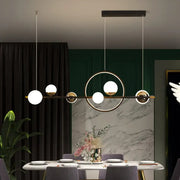 Modern black metal pendant light with spherical glass globes in an asymmetrical geometric pattern for dining room use
