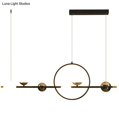 Modern black metal spherical glass pendant light with geometric gold accents for dining room lighting