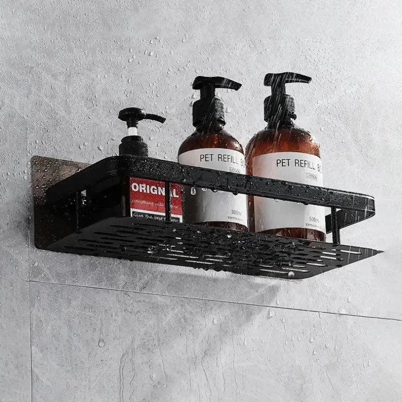 Modern black metal tiered bathroom corner shelves with perforated design holding amber glass pump bottles from decorbites bathroom
