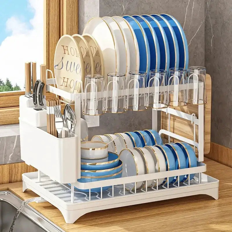Modern black metal two tier dish drainer rack with white two-tier dish drainer holding gold trimmed plates and glassware