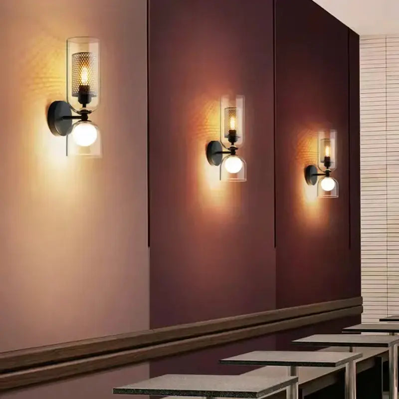 Modern black metal wall light with clear glass shades and warm glowing bulb ideal for bedroom decorbites clear glass decor