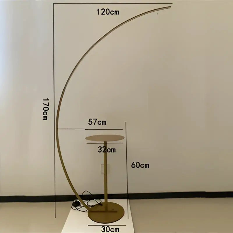 Gold-toned curved arc floor lamp with sleek modern design and circular base for living room use