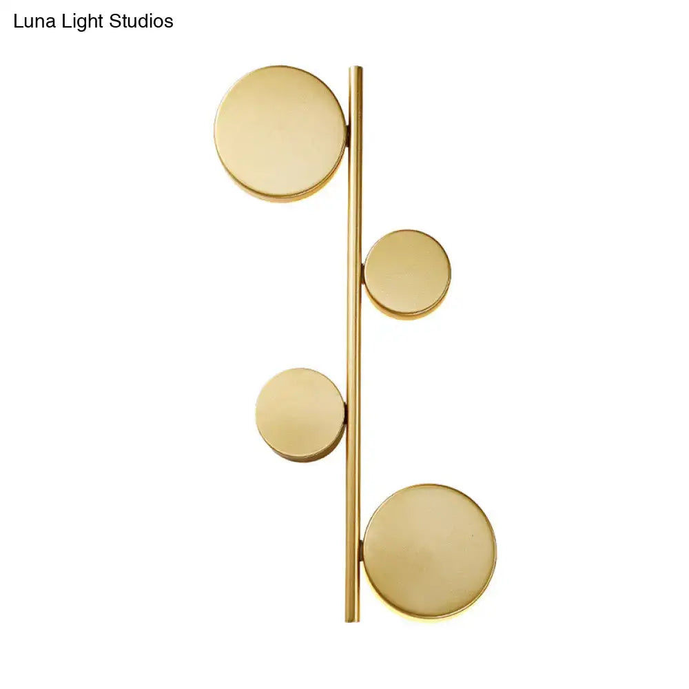 Modern gold-toned circle wall mount LED sconce with four circular discs for minimalist living room decor