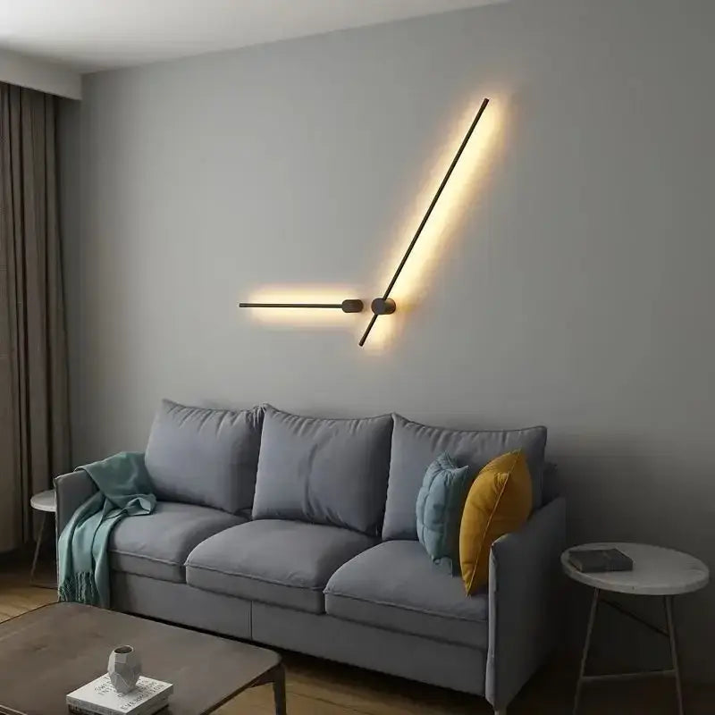 Modern black minimalist wall lamp with two angled arms emitting warm glow in decorbites led strip staircase light