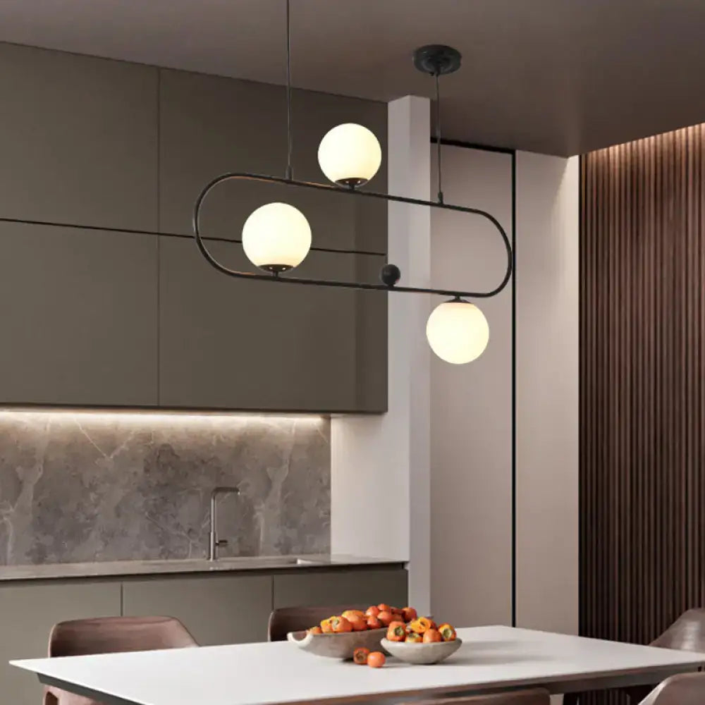 Modern black metal minimalist ellipse ceiling light with three glowing white globes for living room use