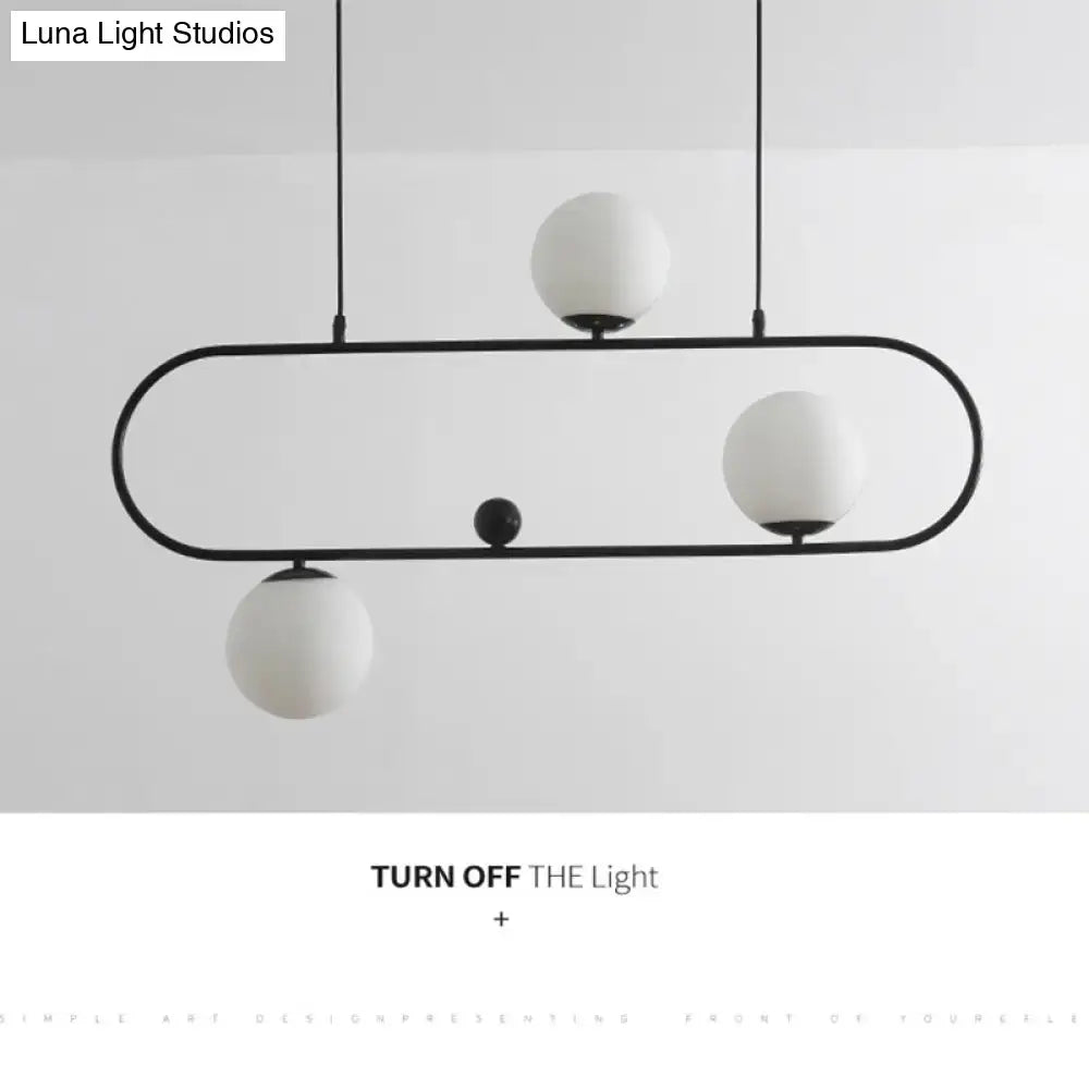 Modern black minimalist ellipse ceiling light with three white glass globes and a central black orb for living room
