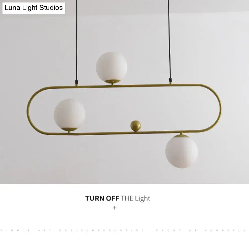 Gold-toned oval chandelier ceiling light with white glass globes and a minimalist ellipse design for living room use