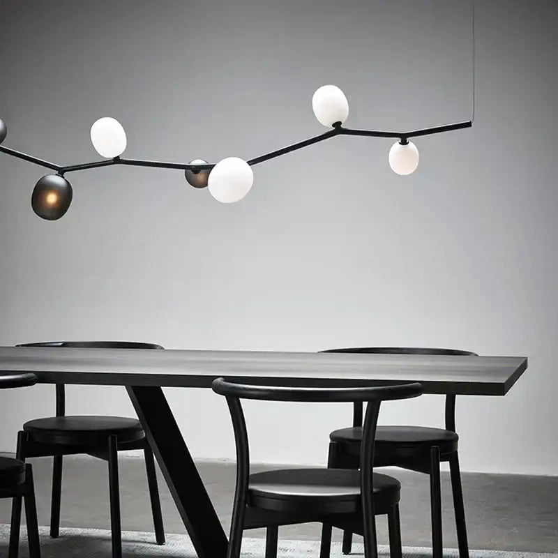 Modern black minimalist glass branch chandelier featuring spherical white and dark metallic globe bulbs for dining room decorbites glass branch lighting