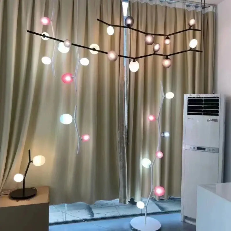Modern black minimalist decorbites glass branch chandelier with spherical warm white, soft pink, and cool blue bulbs for dining room