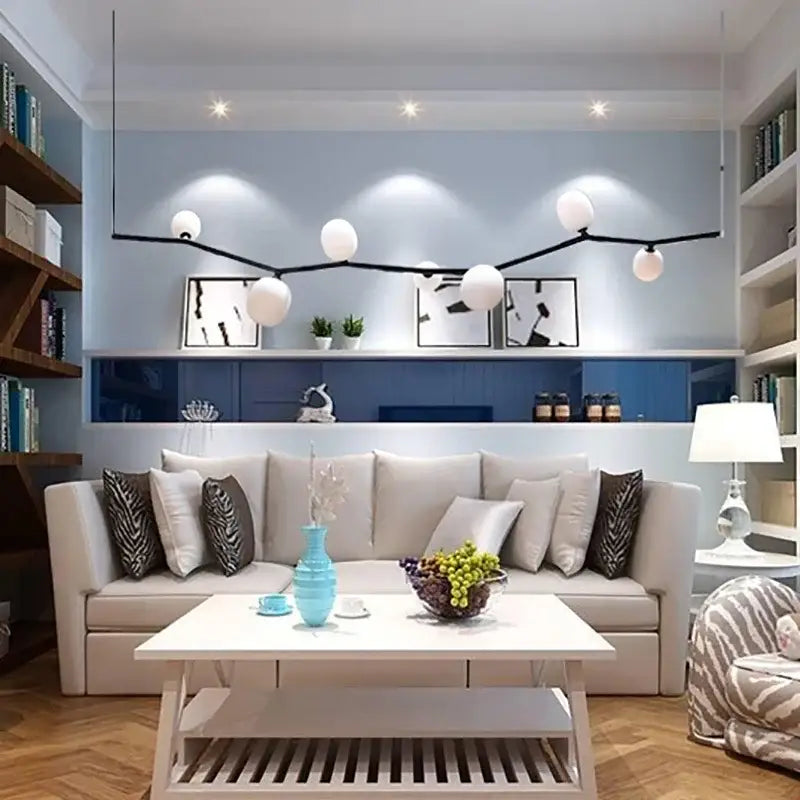 A sleek modern turquoise ceramic vase on a coffee table complements the decorbites glass branch chandelier dining room light
