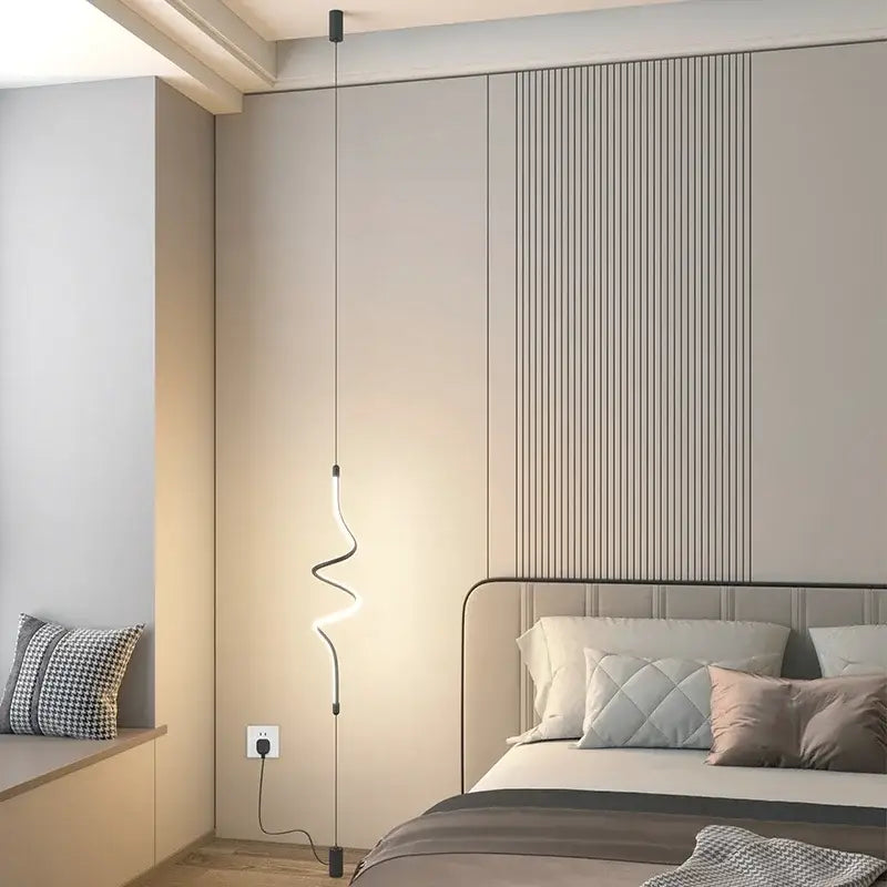 Modern black minimalist led floor lamp with curved glowing white led light suspended by thin black cords for living room