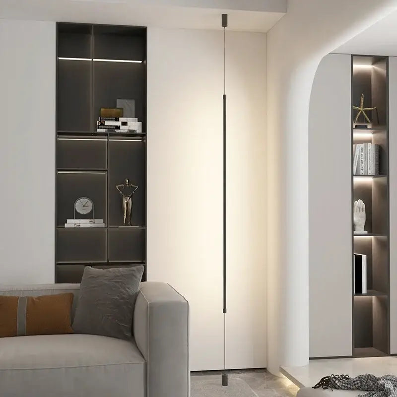 A modern black minimalist led floor lamp with a slender cylindrical body providing warm ambient lighting