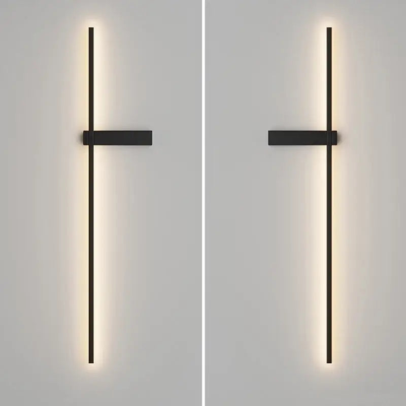 Modern black minimalist led wall lights with sleek vertical bar and horizontal crossbar emitting warm ambient light by decorbites led wall