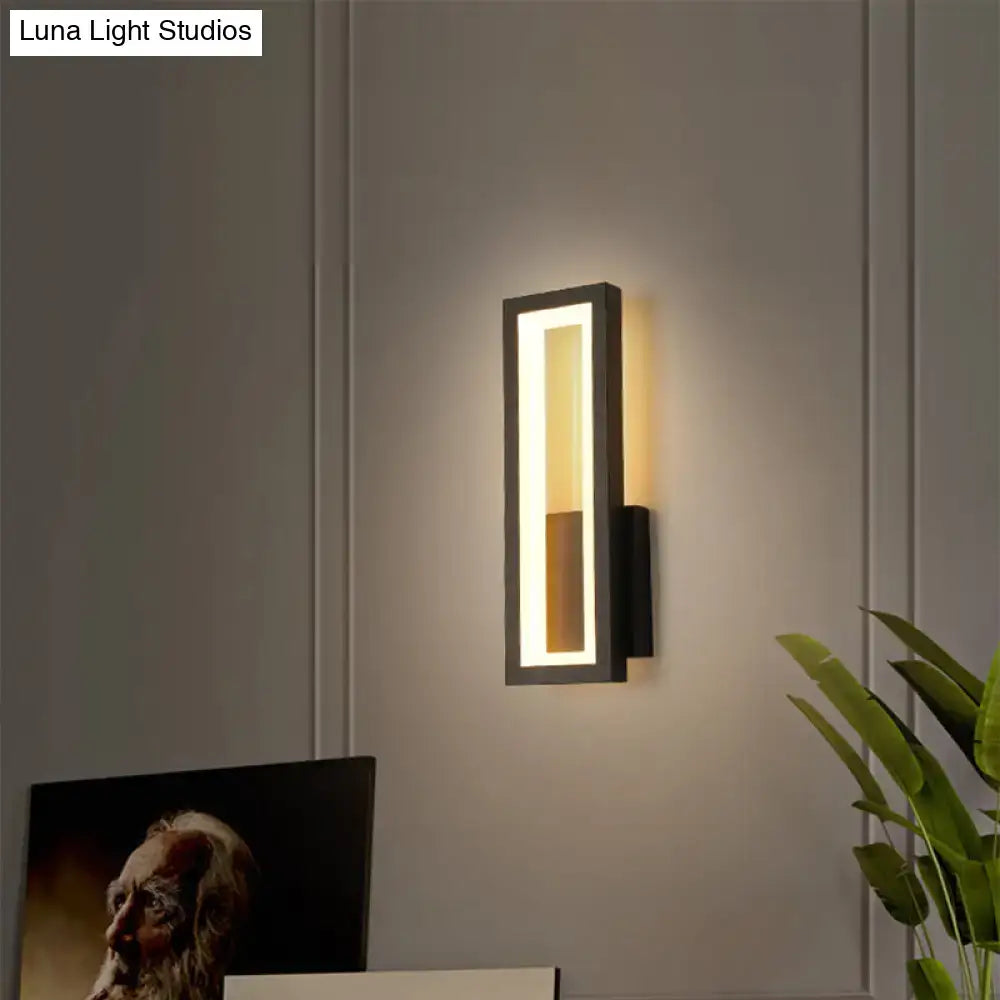 Modern black minimalist led wall sconce with a sleek rectangular design and warm lighting for foyer use