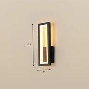 Modern black minimalist led wall sconce with vertical rectangular design and warm illuminated translucent panel for foyer lighting