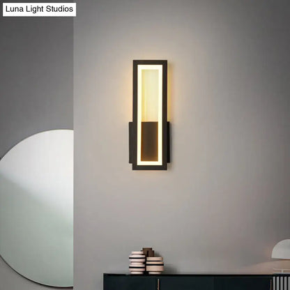 Modern black minimalist wall sconce with sleek rectangular design and warm LED lighting for foyer use